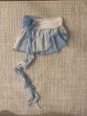 Light blue and white asymmetrical mini skirt with strappy lace flower